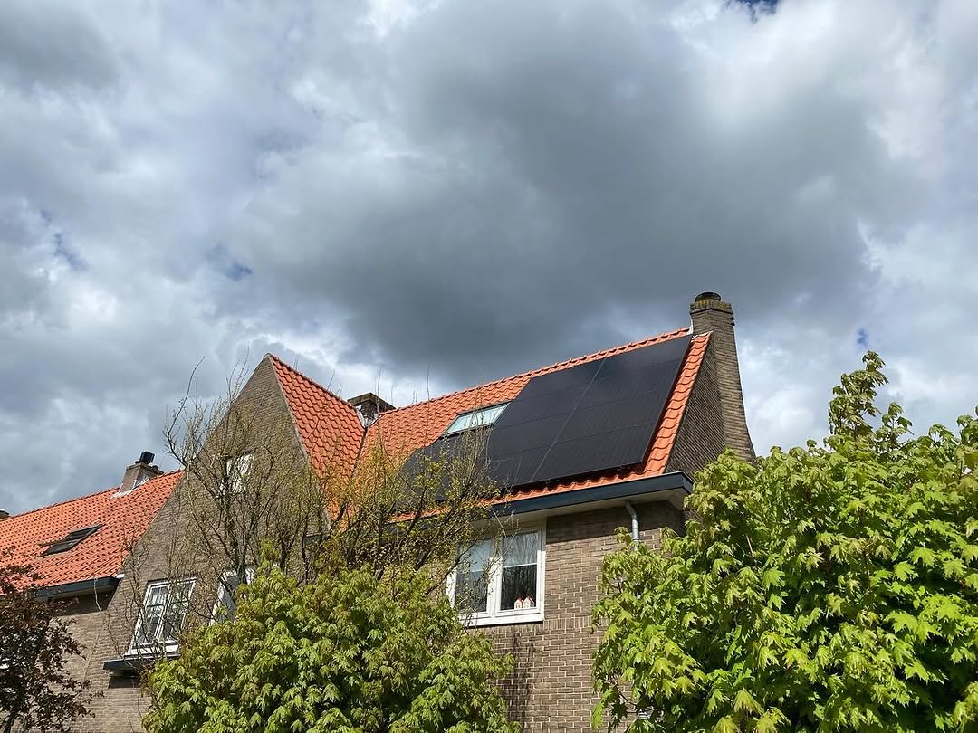 Eindresultaat dakrenovatie Hilversum met rood pannendak en zonnepanelen